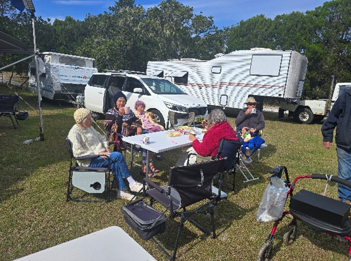 Members gathered around a table at Broadwater Bush Camp